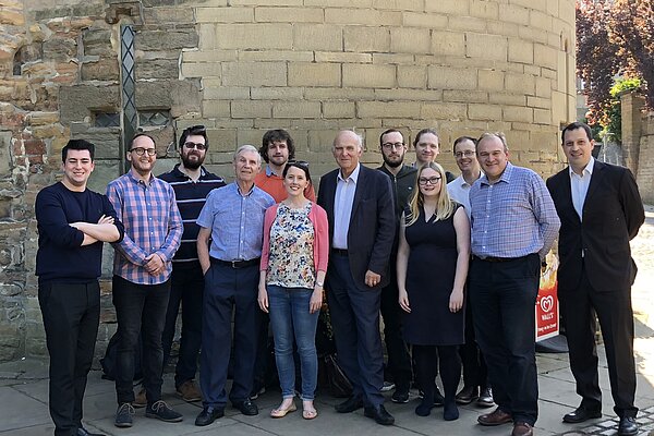 A group of Lib Dem activists, including Ed Davey and Vince Cable, look towards the camera in front of the walls of Nottingham Castle