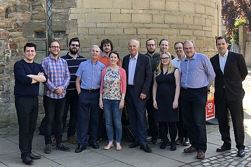 A group of Lib Dem activists, including Ed Davey and Vince Cable, look towards the camera in front of the walls of Nottingham Castle